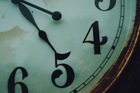 brown wooden framed analog clock