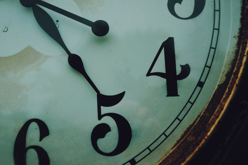 brown wooden framed analog clock