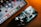 A smartphone and a tablet are placed on a surface with a warm lighting ambiance. The smartphone screen displays an artistic, abstract wallpaper, while the tablet shows a variety of colorful application icons, including Google, Netflix, and others.