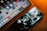 A smartphone and a tablet are placed on a surface with a warm lighting ambiance. The smartphone screen displays an artistic, abstract wallpaper, while the tablet shows a variety of colorful application icons, including Google, Netflix, and others.