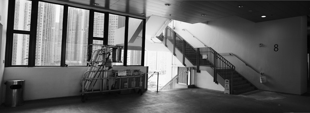A clean, well-lit stairwell in a Brooklyn building, showcasing spotless floors and tidy entryways.