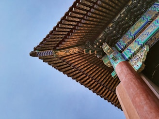 Intricate palace architecture with detailed carvings and vibrant frescoes under a clear blue sky.