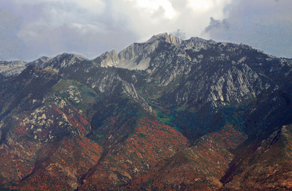 brown and gray rocky mountain under white cloudy sky during daytime