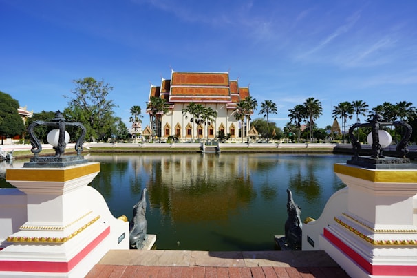 A serene temple by a pond, reflecting the village's cultural heritage.