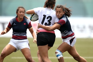 women in black and white jersey shirt playing soccer