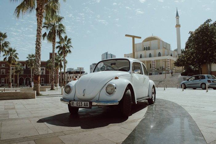 white classic car on road during daytime