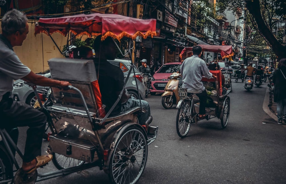 man in gray t-shirt riding on black and red trike