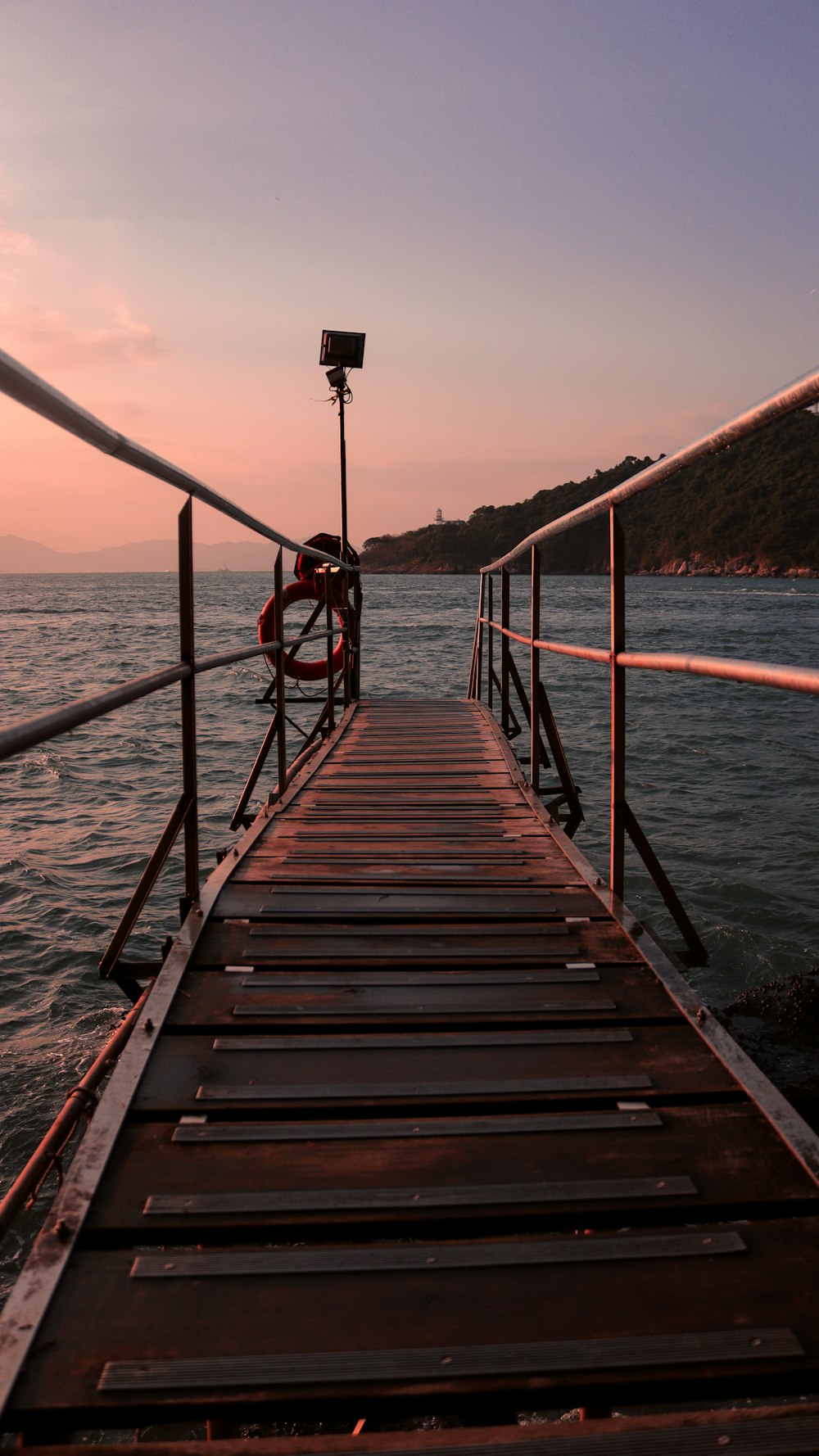 brown wooden dock on sea during daytime