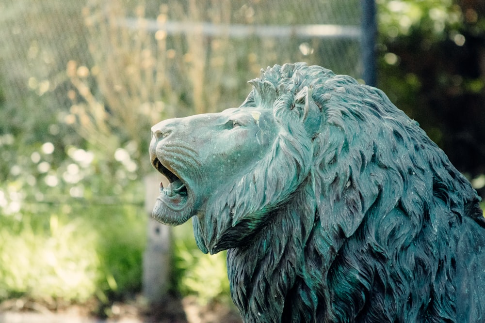 green lion head statue during daytime