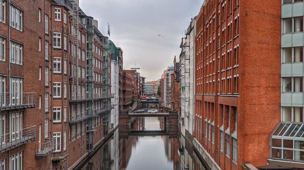 brown and white concrete building beside river during daytime