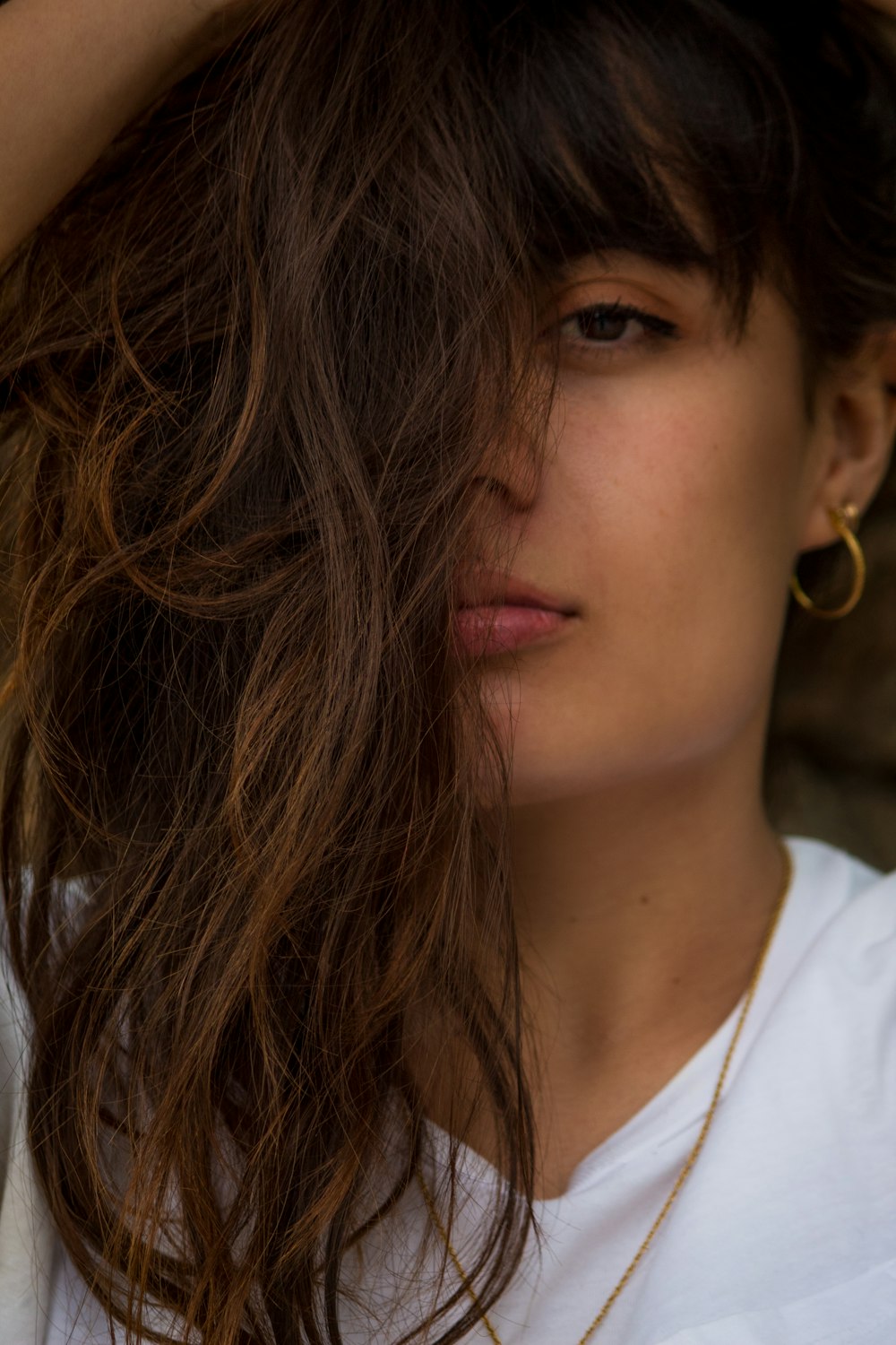 woman in white shirt with brown hair