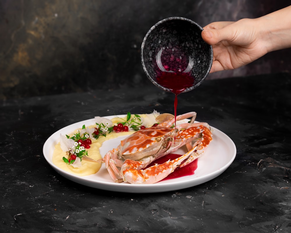 person holding stainless steel spoon and fork eating cooked food on white ceramic plate