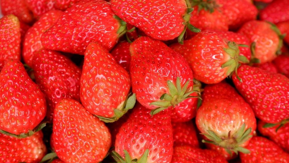 red strawberries on white ceramic plate