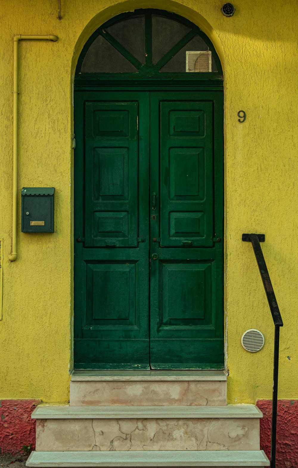 blue wooden door with black handle