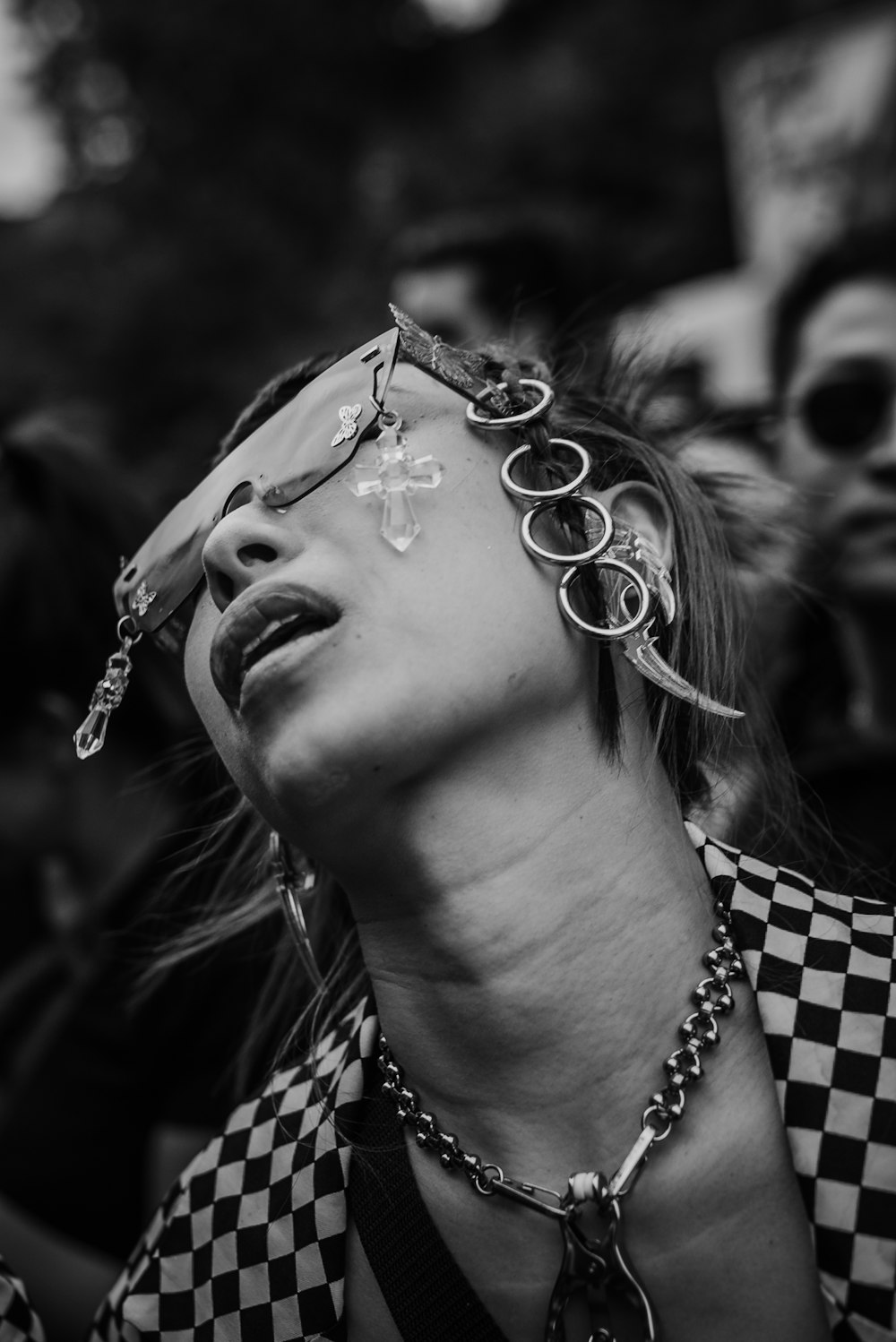 grayscale photo of woman with silver earrings