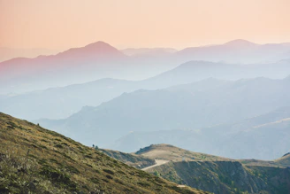 green and brown mountains under white sky during daytime