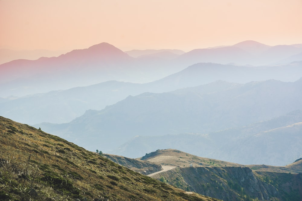 green and brown mountains under white sky during daytime