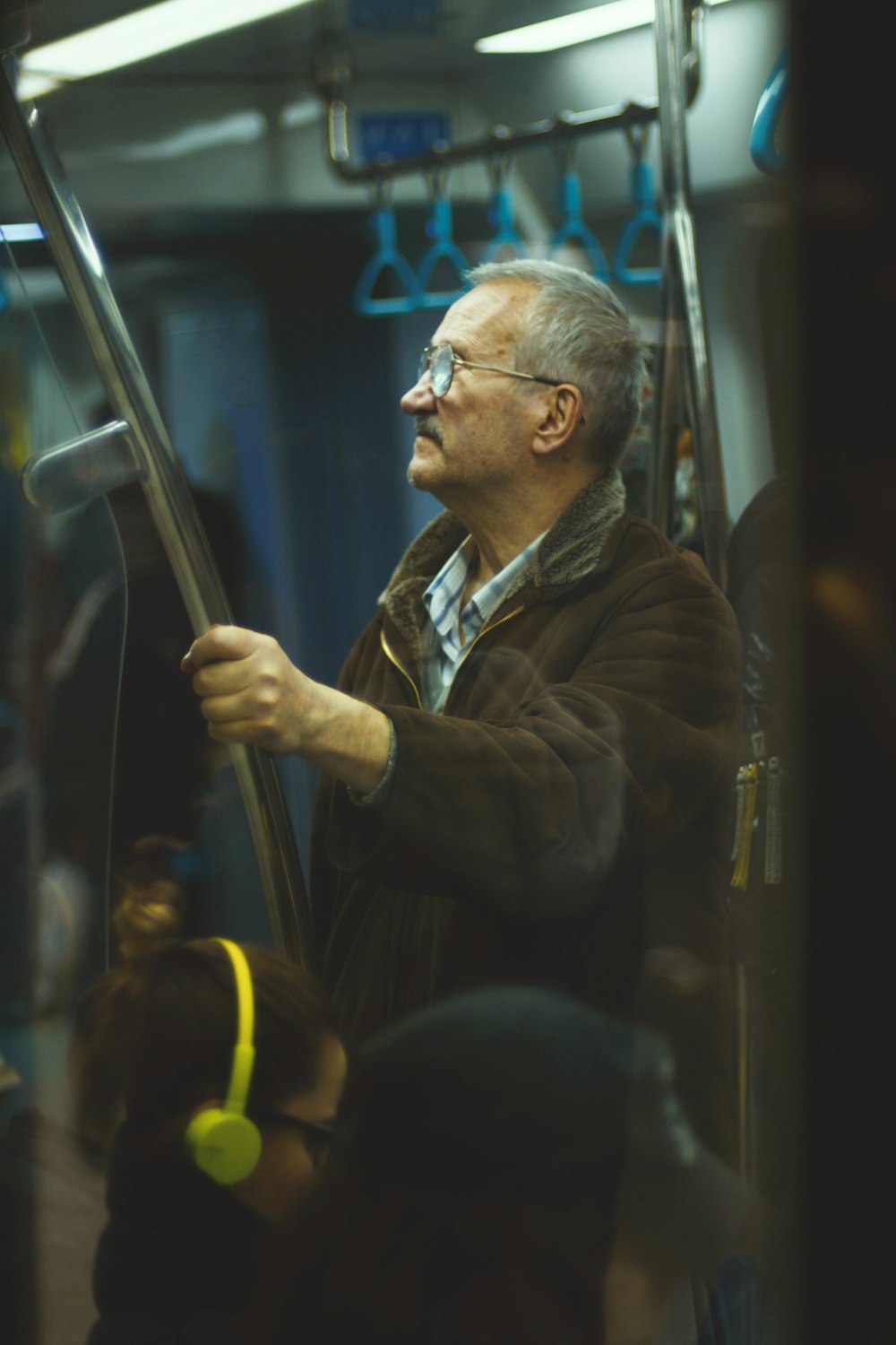 man in brown jacket wearing eyeglasses