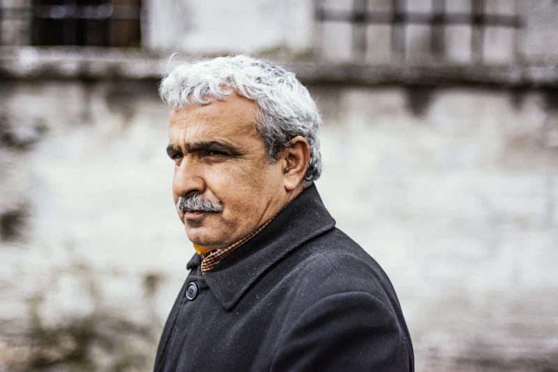 distinguished man in a black button-up shirt