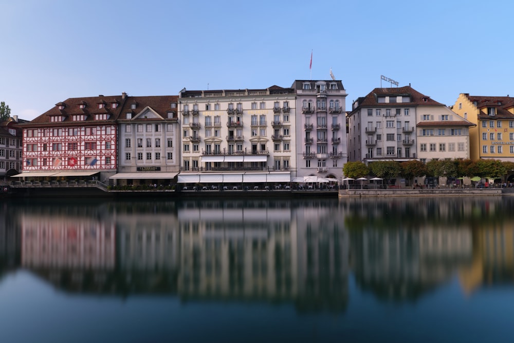 brown and white concrete building beside body of water during daytime