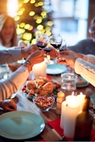 A family enjoying a festive dinner around a table filled with Christmas treats.