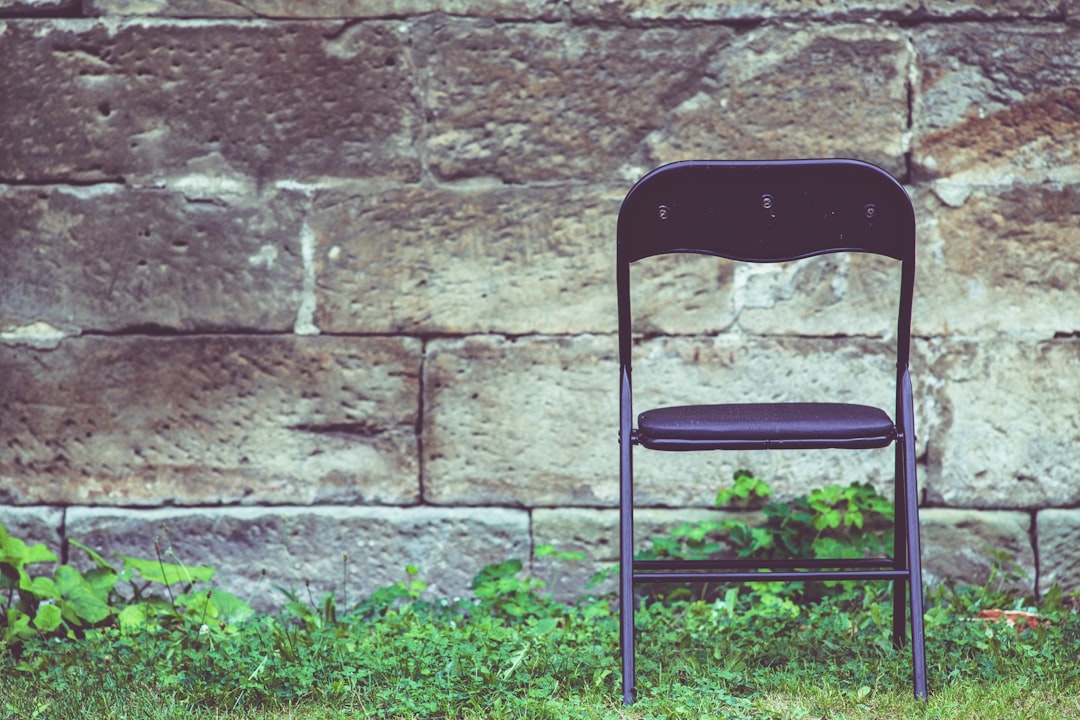 black metal chair on green grass