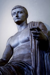 man statue near white wall