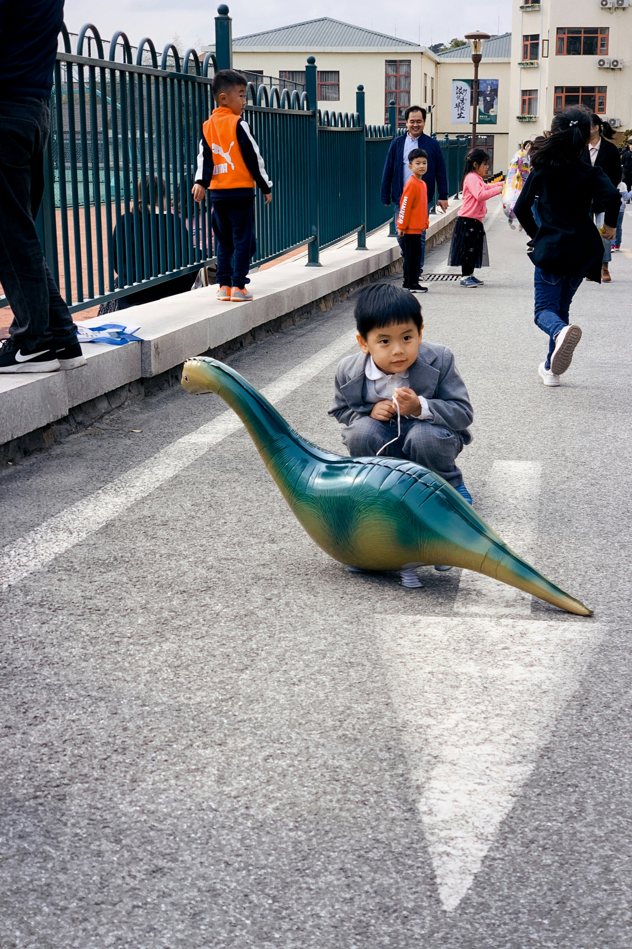 boy in green jacket riding green inflatable duck
