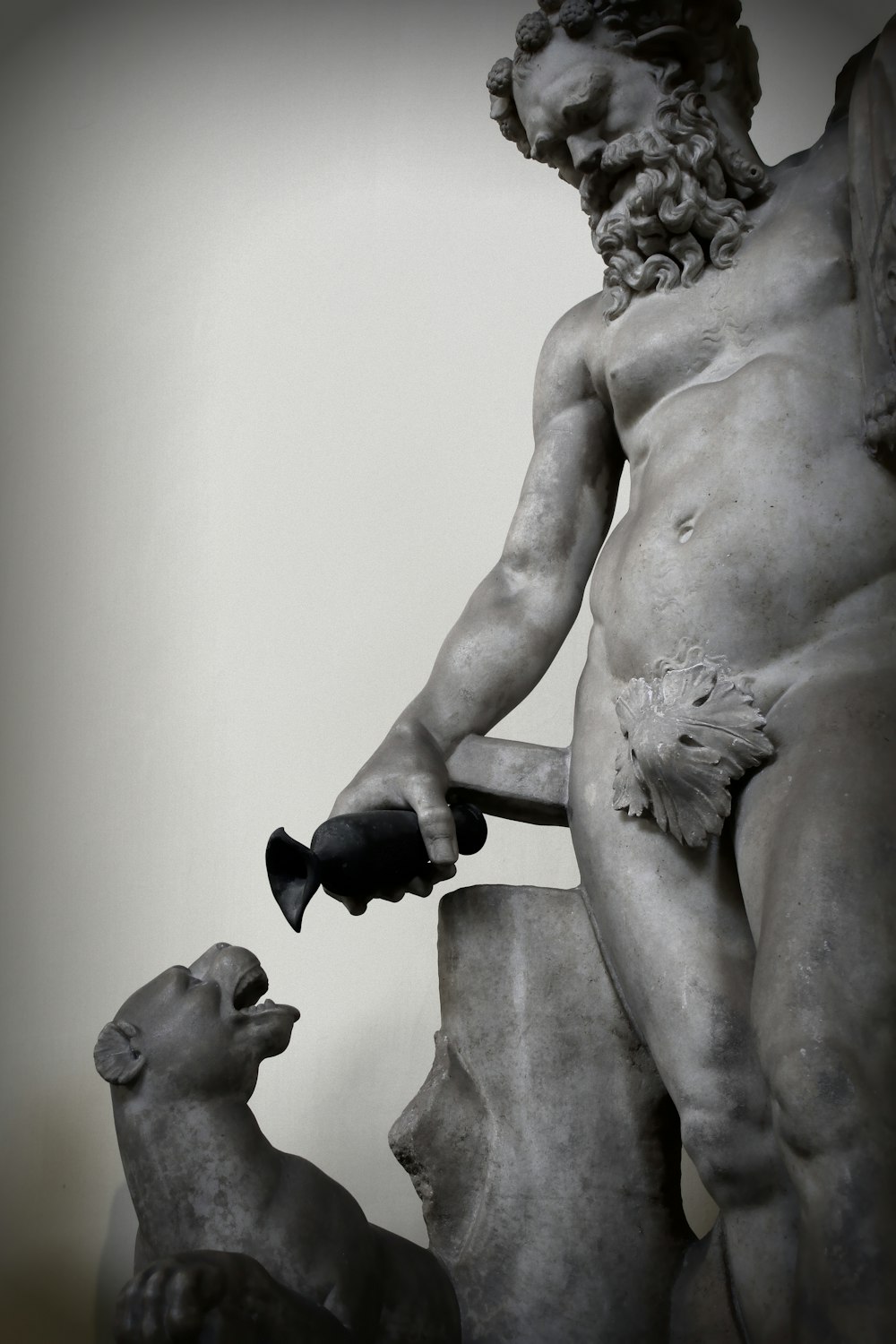 man holding black steel pipe statue