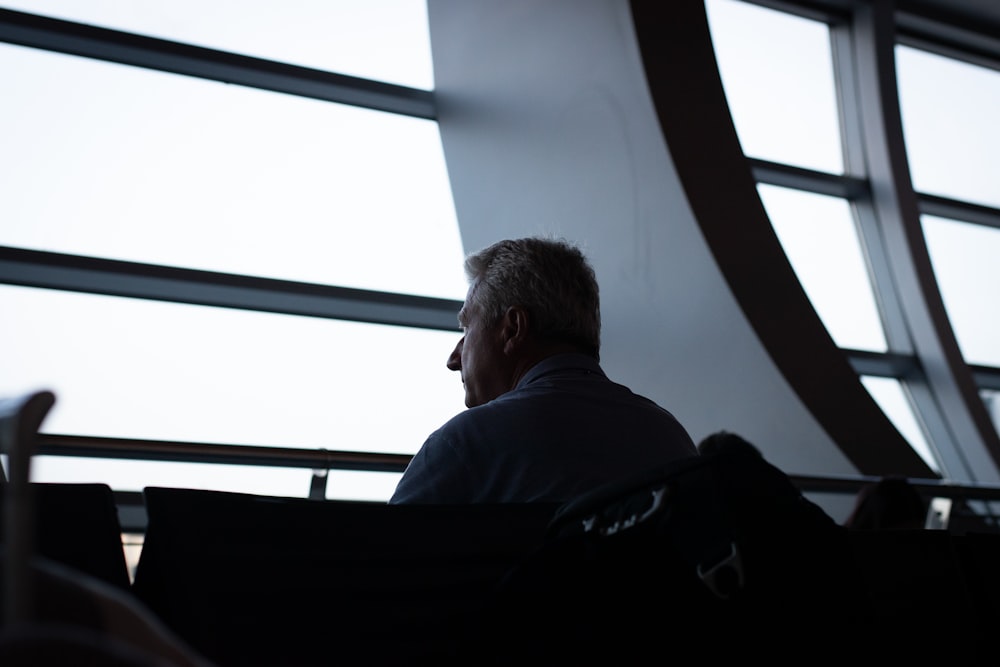 man in black jacket sitting on chair