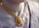 A close-up view of an ornate gold necklace with intricate designs and colorful gemstones, worn by a person dressed in a traditional garment with intricate patterns.