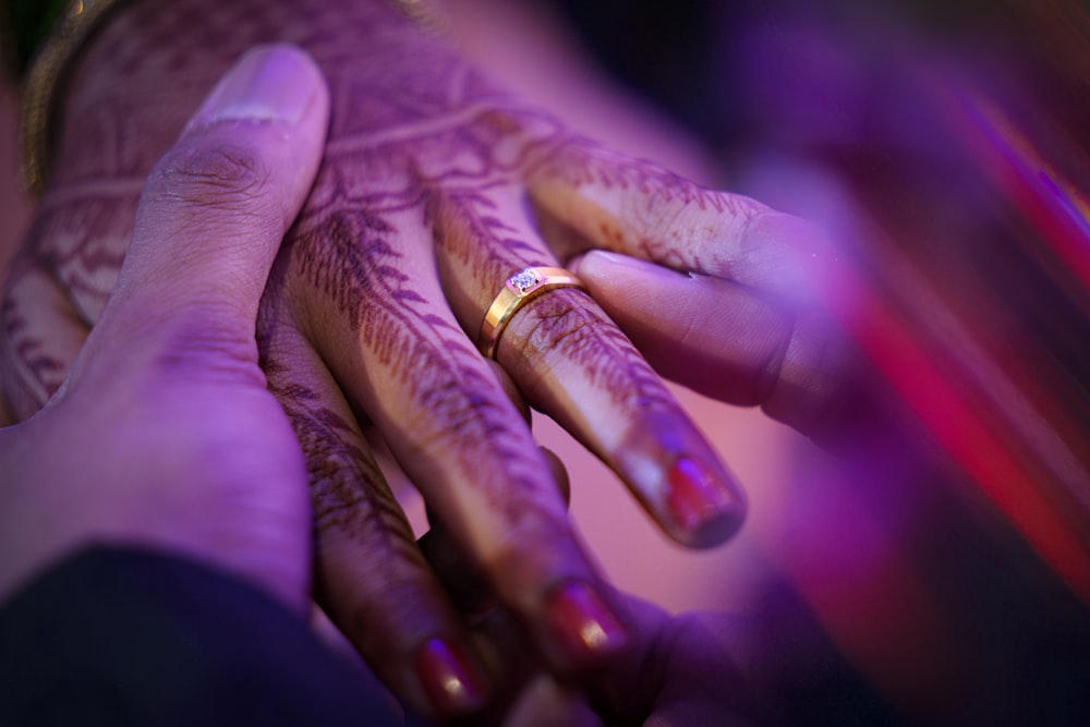 person wearing gold wedding band