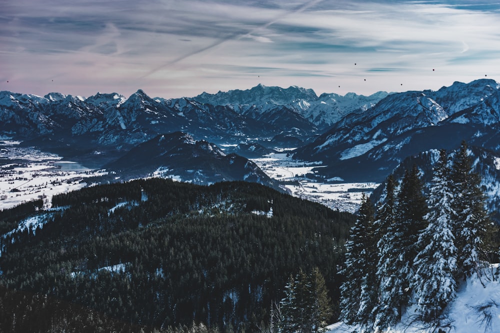 snow covered mountain under cloudy sky during daytime