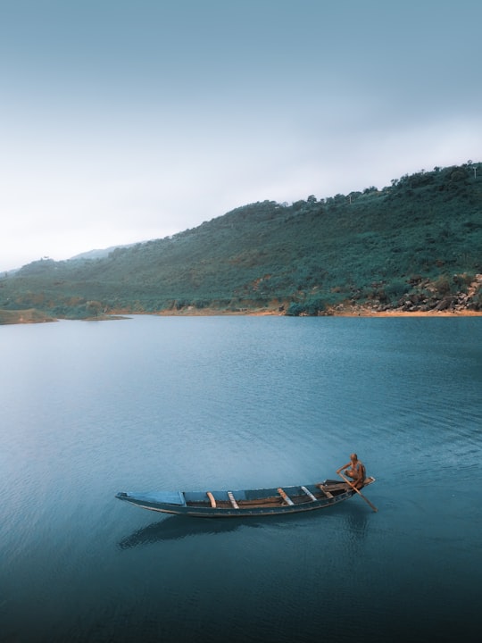 brown boat on body of water during daytime in Sylhet Bangladesh