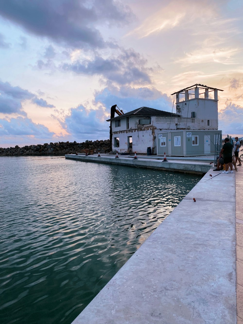 people walking on dock near white building during daytime