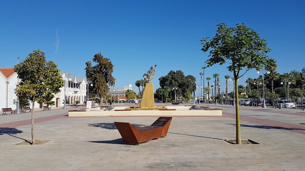 brown concrete fountain in the middle of the park