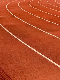 a red running track with white lines on it