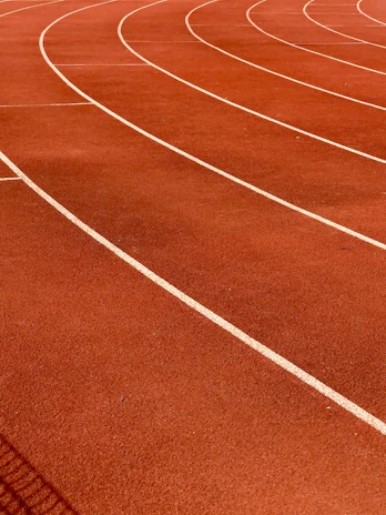 a red running track with white lines on it