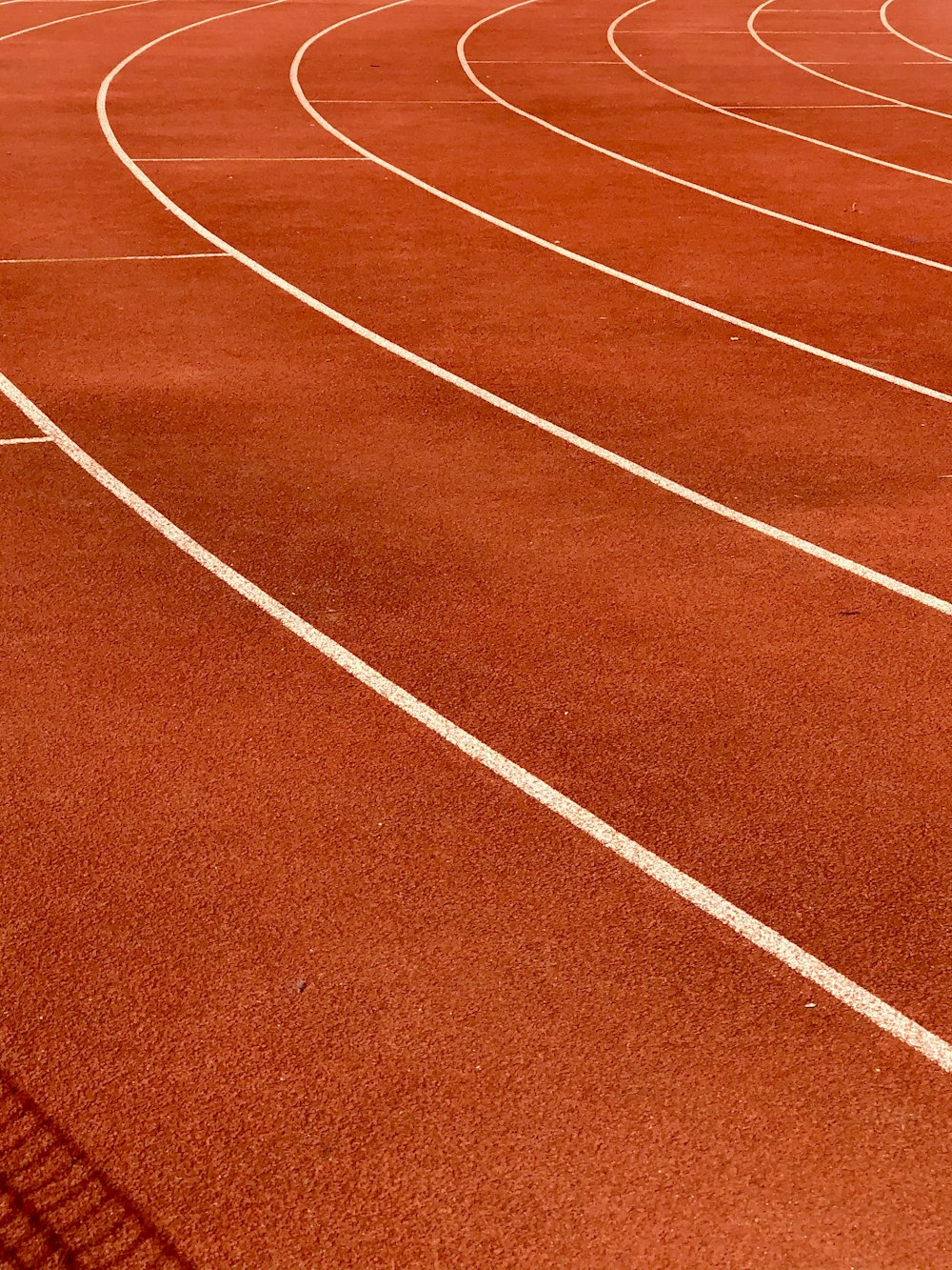 a red running track with white lines on it
