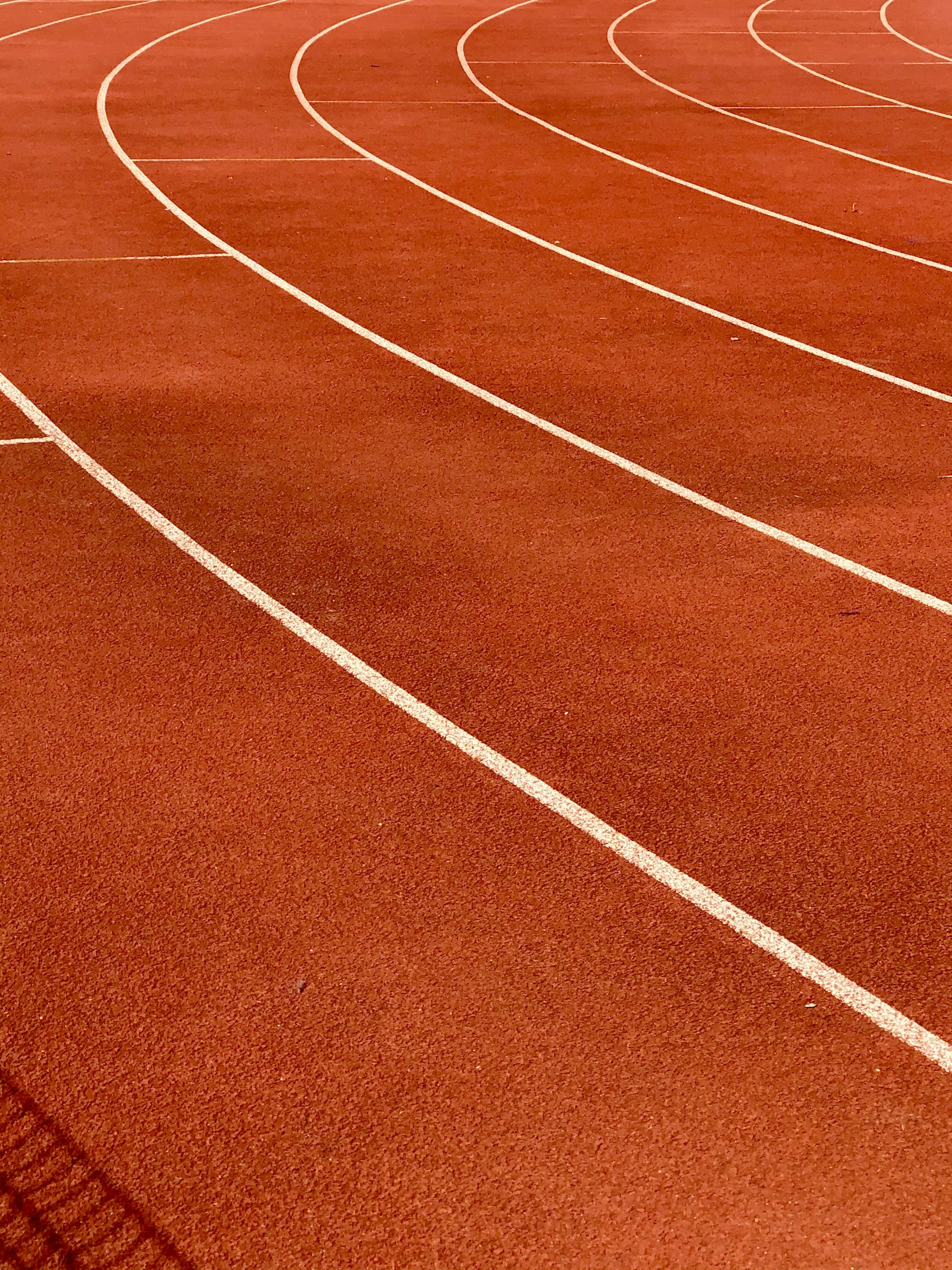 a red running track with white lines on it
