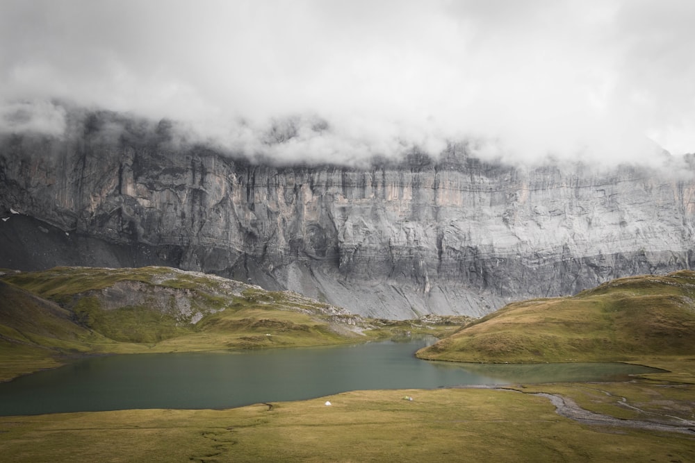 a mountain range with a lake in the foreground