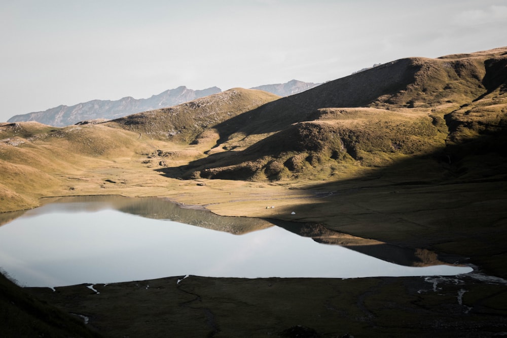 brown mountains near lake during daytime