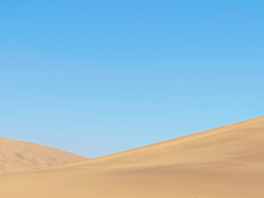 brown sand under blue sky during daytime