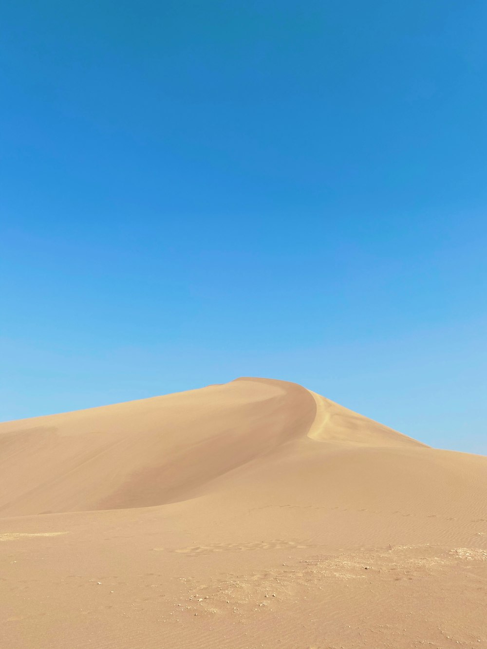 brauner Sand unter blauem Himmel tagsüber