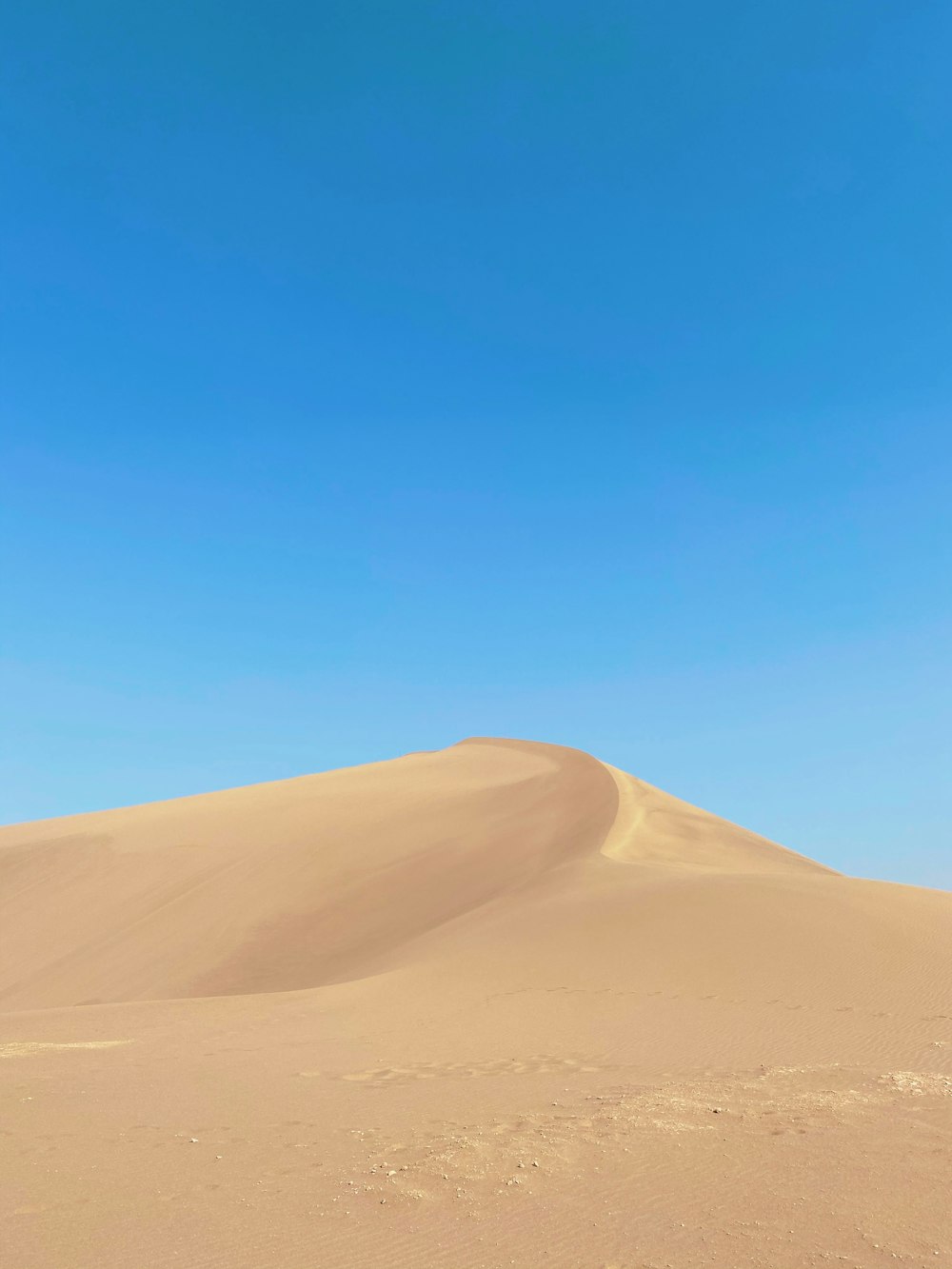 brown sand under blue sky during daytime