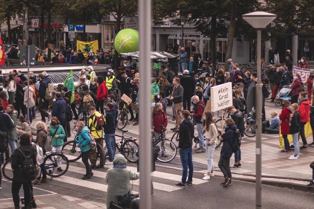 people riding bicycle on road during daytime