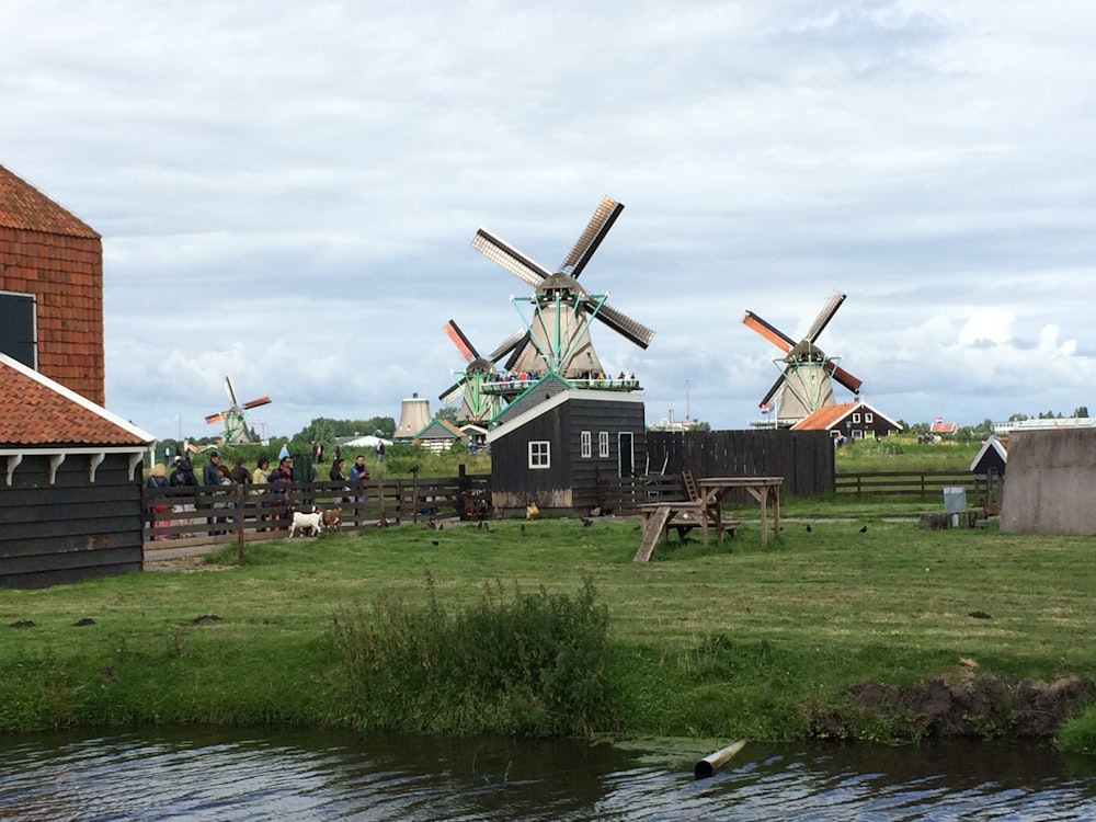 windmill near body of water during daytime