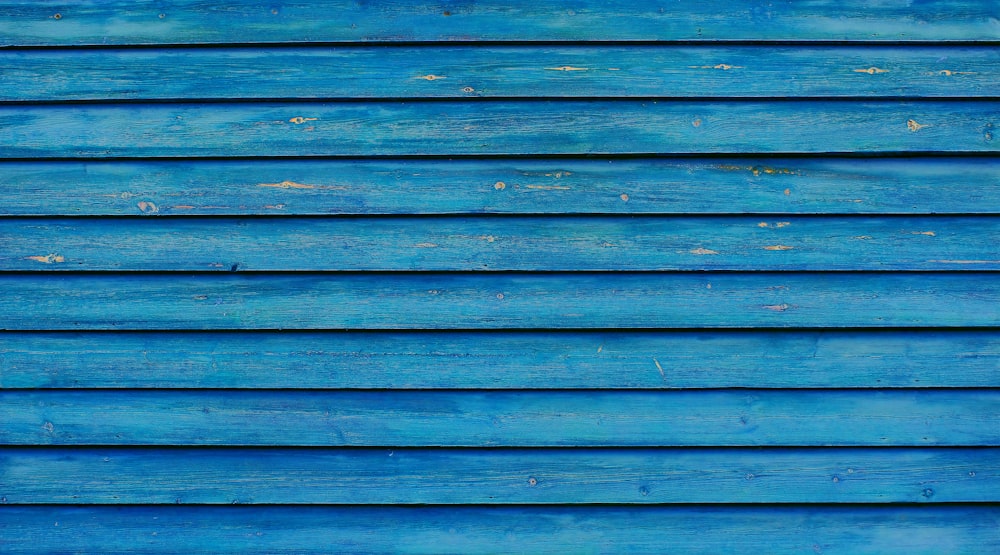 blue wooden wall with blue and white paint