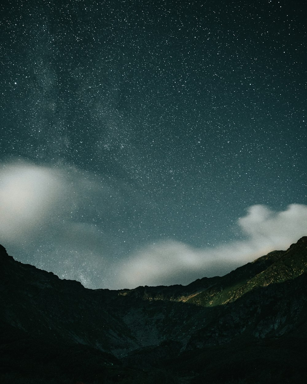 black and white mountain under starry night