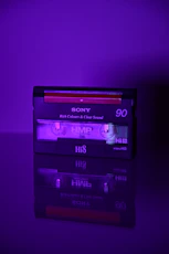 a purple cassette player sitting on top of a table